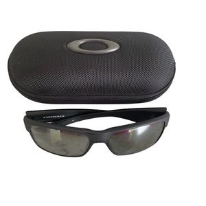 Oakley men’s sunglasses with purple logo. Includes case. Excellent condition.